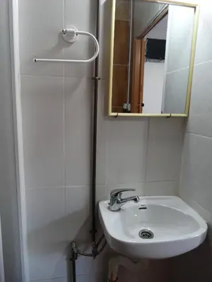a bathroom with a sink and a shower and a mirror at Pensión Teruel in Barcelona
