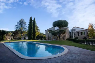 a swimming pool in a yard next to a house at Hotel & Spa Golden Barcelona in Vallromanas