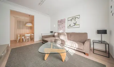 a living room with a couch and a glass table at You Stylish Diagonal Apartments in Barcelona