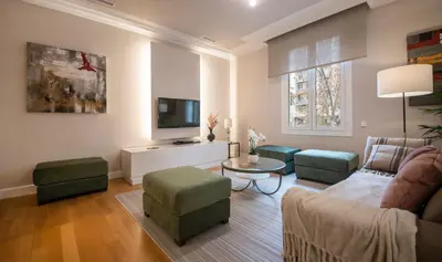 a living room with a couch and chairs and a tv at You Stylish Diagonal Apartments in Barcelona