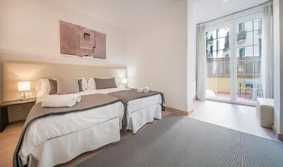 a bedroom with a large bed and a large window at You Stylish Diagonal Apartments in Barcelona