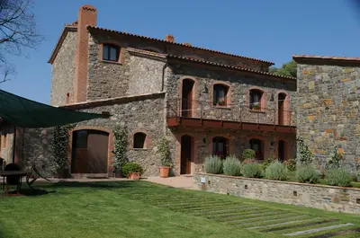 an external view of a building with a yard at Hotel Rural Can Vila in Sant Esteve de Palautordera