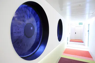 a room with a large blue eye on the wall at Room Mate Pau, Barcelona in Barcelona