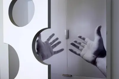a hand pressed against a door with a mirror at Room Mate Pau, Barcelona in Barcelona