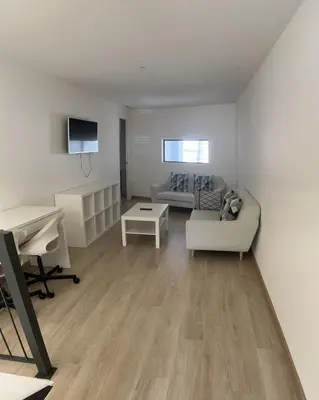 a living room with a couch and a desk at Castro Exclusive Residences Sant Pau in Barcelona