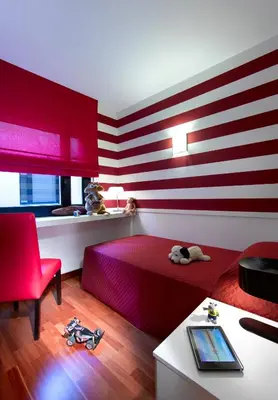 a room with a red bed and a red chair at Castro Exclusive Residences Sant Pau in Barcelona