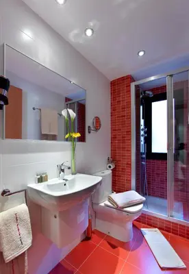 a bathroom with a sink and a toilet and a mirror at Castro Exclusive Residences Sant Pau in Barcelona