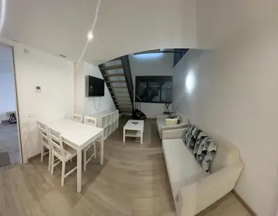 a living room with a couch and a table at Castro Exclusive Residences Sant Pau in Barcelona