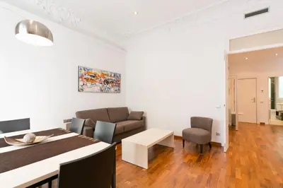 a living room with a couch and a table at Aspasios Rambla Catalunya Apartments in Barcelona