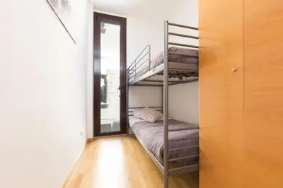 a room with two bunk beds and a door at Matarolux16 in Mataró