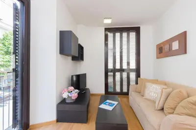 a living room with a couch and a table at Matarolux16 in Mataró