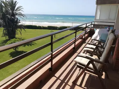 a balcony with chairs and a view of the ocean at Relaxing Seafront Apartment Gavà 20 Min from BCN in Gavà