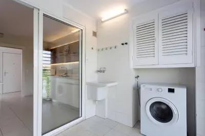 a bathroom with a washing machine and a sink at Relaxing Seafront Apartment Gavà 20 Min from BCN in Gavà
