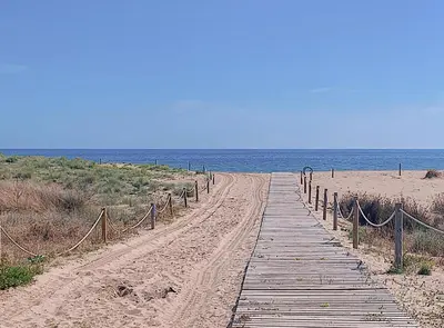 a wooden path leading to the beach at Siroco by Seaside Homes in Castelldefels