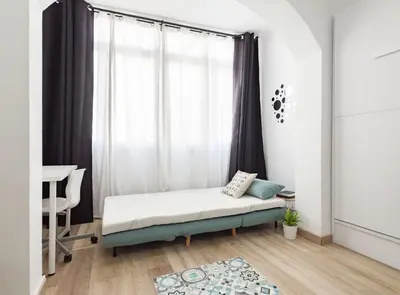 a bedroom with a bed in front of a window at Siroco by Seaside Homes in Castelldefels