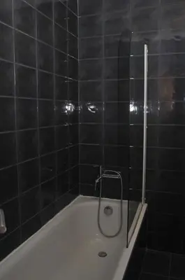 a bathroom with a bath tub with a shower at Hotel Ibiza in Sitges