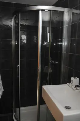 a bathroom with a shower and a sink and a toilet at Hotel Ibiza in Sitges