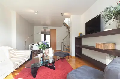 a living room with a white couch and a glass table at My Space Barcelona Guell Terrace Center in Barcelona