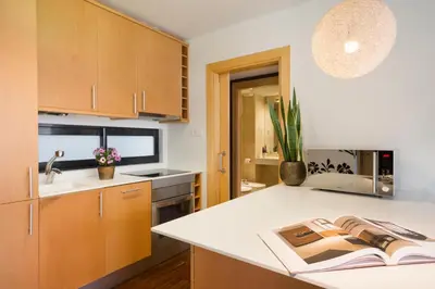a kitchen with a book on top of a counter at My Space Barcelona Executive Apartments Center in Barcelona