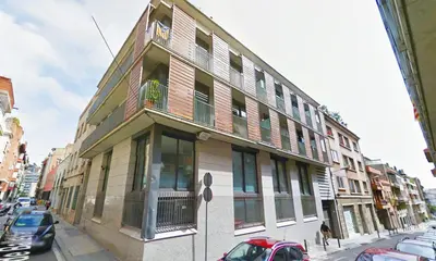 a building on a street with cars parked in front of it at My Space Barcelona Park Güell Apartments in Barcelona