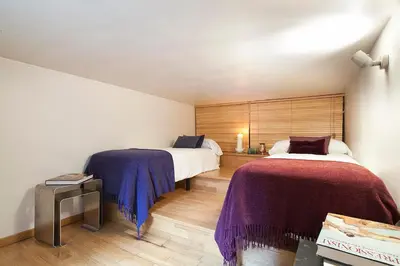 a bedroom with two beds with purple blankets at My Space Barcelona Park Güell Apartments in Barcelona