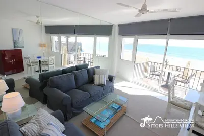 a living room with a blue couch and a table at Apartment Alegria (Happy) in Sitges