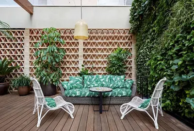 a patio with a couch and two chairs and a table at Radisson Blu 1882 Hotel, Barcelona Sagrada Familia in Barcelona