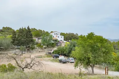 a group of cars parked in a parking lot at Masía Cal Simó - Casa rural con piscina, cerca de Sitges, para celebraciones y eventos in Canyelles