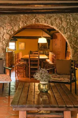 a living room with a table and a dining room at Masía Cal Simó - Casa rural con piscina, cerca de Sitges, para celebraciones y eventos in Canyelles