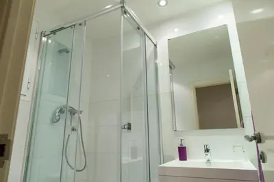 a bathroom with a shower and a sink and a mirror at Apartament Conde Güell in Barcelona