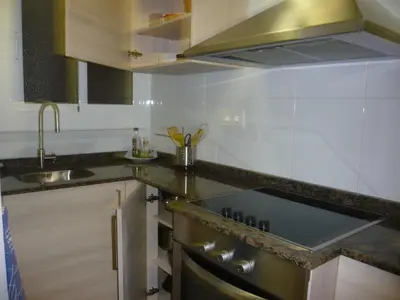 a kitchen with a sink and a stove top oven at Apartament Conde Güell in Barcelona
