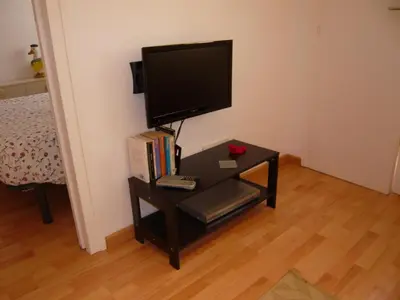 a small table with a computer monitor on top of it at Apartament Conde Güell in Barcelona