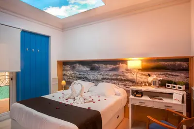 a bedroom with a bed with a painting on the wall at Hotel Ribes Roges in Vilanova i la Geltrú