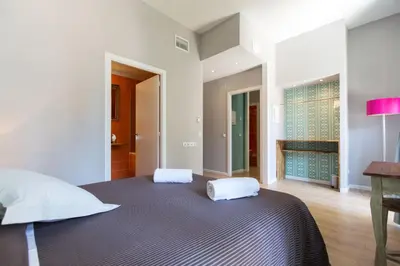 a bedroom with a large bed with two white pillows at Violeta Boutique in Barcelona