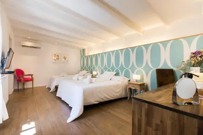 a hotel room with two beds and a wall at Violeta Boutique in Barcelona