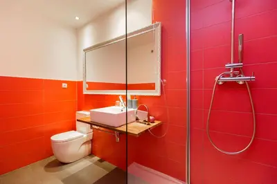 a red bathroom with a toilet and a shower at Violeta Boutique in Barcelona