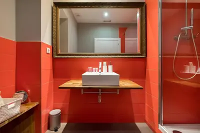 a red bathroom with a sink and a mirror at Violeta Boutique in Barcelona