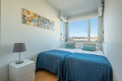a bedroom with a bed and a large window at Rent Top Apartments Forum in Sant Adria de Besos