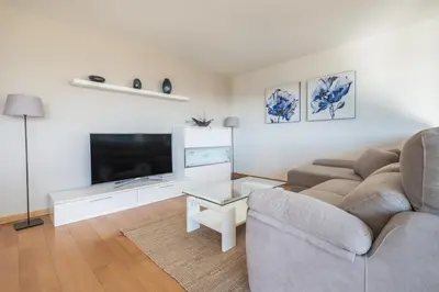 a living room with a couch and a flat screen tv at Rent Top Apartments Forum in Sant Adria de Besos