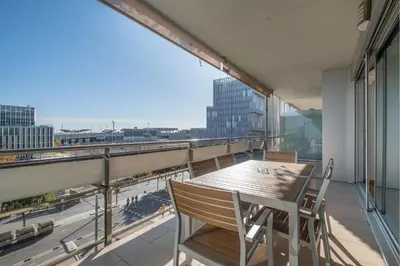 a balcony with a table and chairs and a view of the city at Rent Top Apartments Forum in Sant Adria de Besos