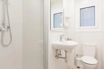 a bathroom with a toilet and a sink and a shower at Novus Homes Barcelona Collblanc in Hospitalet de Llobregat