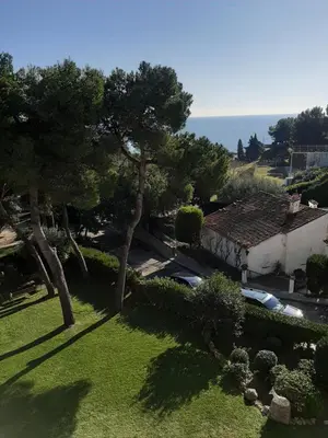 an aerial view of a house with trees and the ocean at White Stones Beach In Sant Pol de Mar in San Pol de Mar