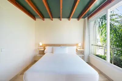 a white bed in a room with a window at MAREA Hotel in Vilanova i la Geltrú
