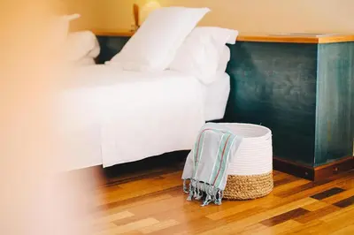 a bedroom with a bed and a basket on the floor at MAREA Hotel in Vilanova i la Geltrú