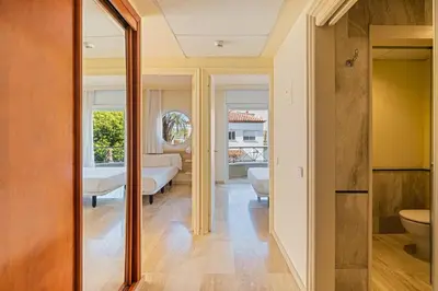 a hallway with a bathroom and a bedroom with a bed at MAREA Hotel in Vilanova i la Geltrú