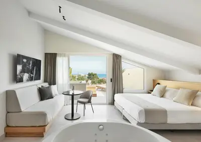 a hotel room with a bed and a bath tub at Hotel restaurant Ceferino in Vilanova i la Geltrú