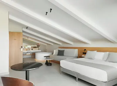 a bedroom with a large bed and a table at Hotel restaurant Ceferino in Vilanova i la Geltrú