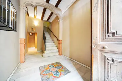 a hallway with a door and a rug on the floor at Numa Barcelona Roca in Barcelona