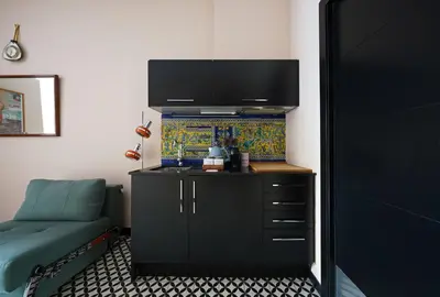 a bedroom with a black dresser with a tv on the wall at Numa Barcelona Roca in Barcelona