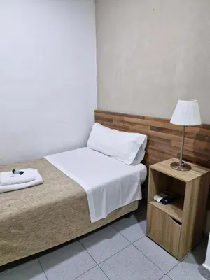 a bedroom with a bed and a table with a lamp at Hostal Elkano in Barcelona